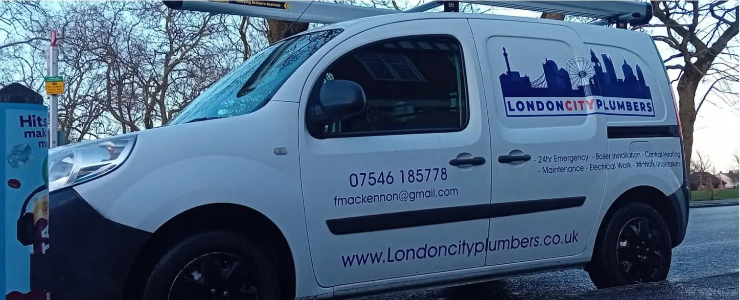 White London City Plumbers van with skyline livery, phone number and services on the side, parked by a London park
